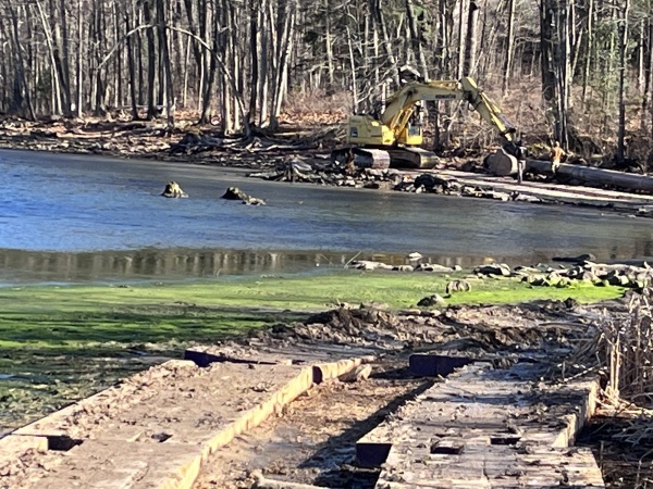 Backhoe near waters edge at the cove